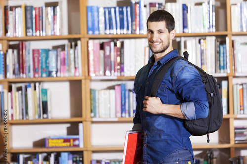 Smiling male student at the library