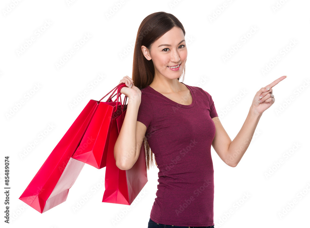 Asian woman hold with shopping bag and finger point up Asian woman hold with shopping bag and finger point up