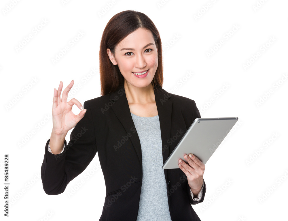 Beautiful businesswoman use of tablet and ok sign gesture Beautiful businesswoman use of tablet and ok sign gesture