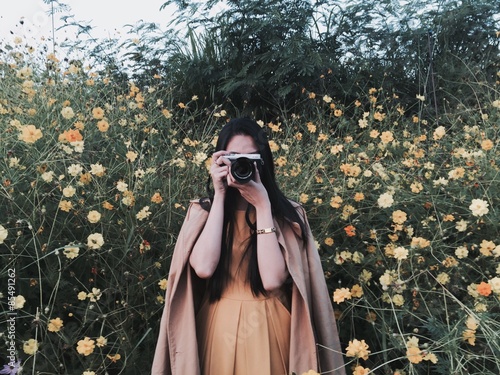 the asain girl taking a photo