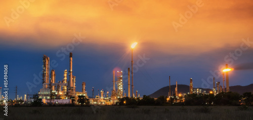 Big Industrial oil tanks in a refinery with treatment pond at industrial plants. © weerasak