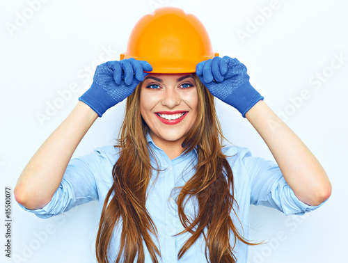 Toothy smiling business woman wearing a building helmet