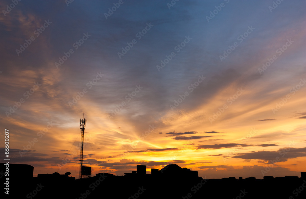 Dramatic twilight sky over silhouetted cityscape