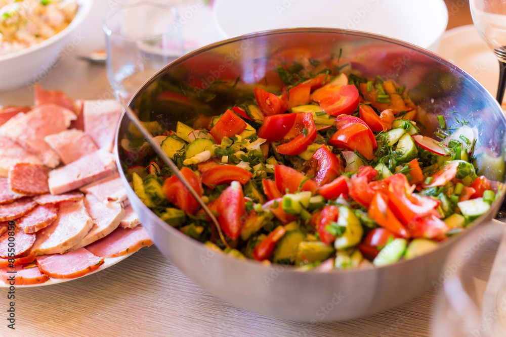 sliced fresh vegetable salad of tomatoes , cucumbers and green onions with olive oil