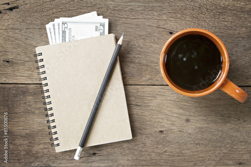 Coffee and notebook on wooden background