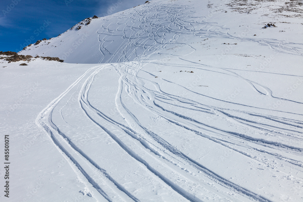 traces of the skis on the snow, traces of snowboarding on the snow-covered slope