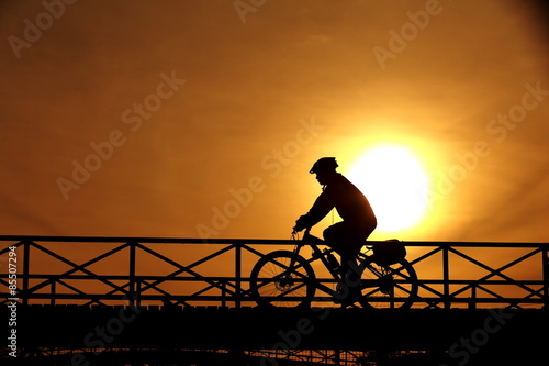 silhouette of a cyclist at sunset