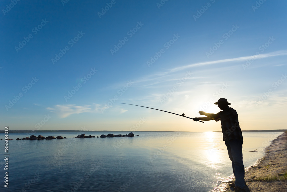 fisher silhouette on a river fisher silhouette on a river
