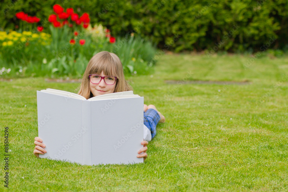 Girl reading a book in a garden Girl reading a book in a garden