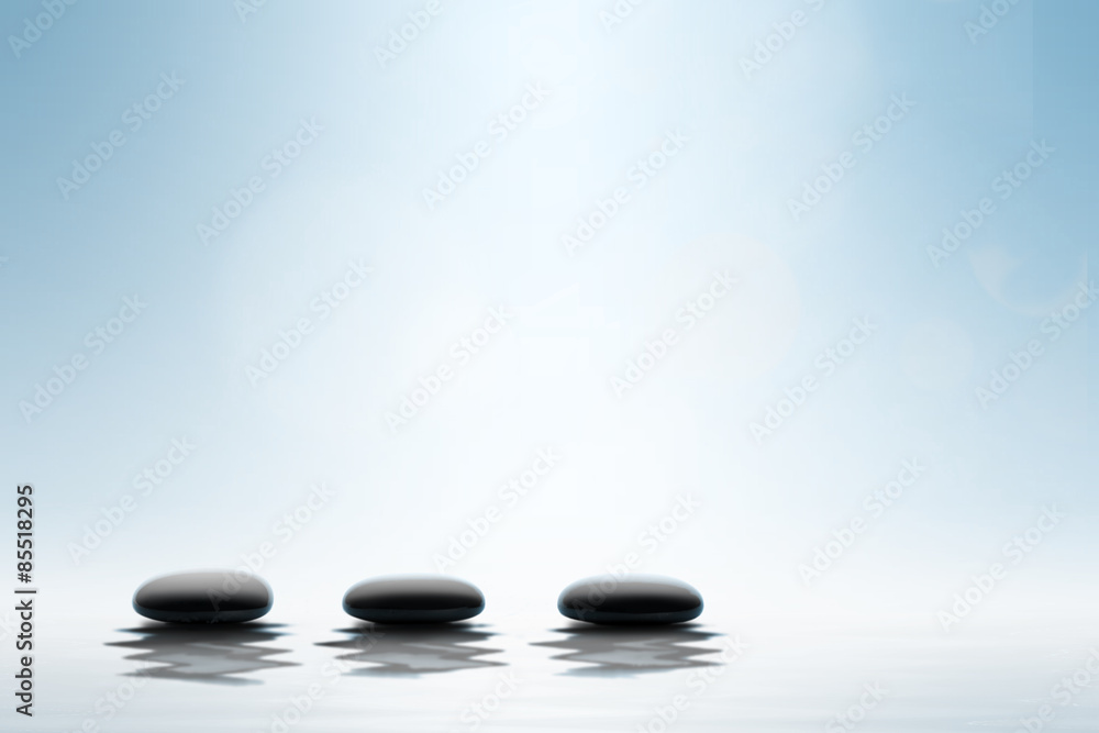 Zen concept. Black spa stones on blue background.