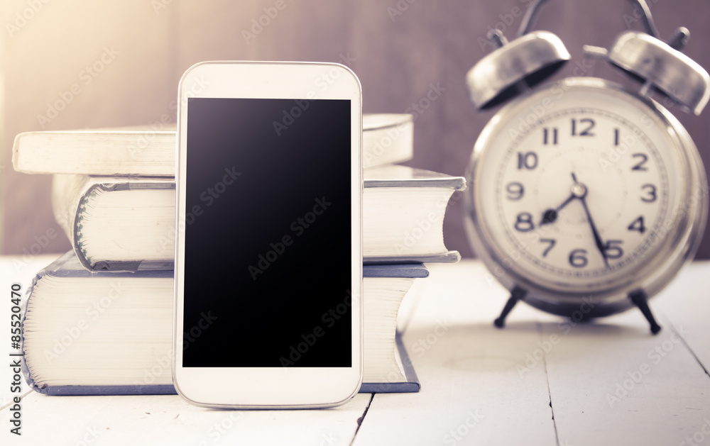 smart phone,cellphone on with book and alarm clock in vintage smart phone,cellphone on with book and alarm clock in vintage