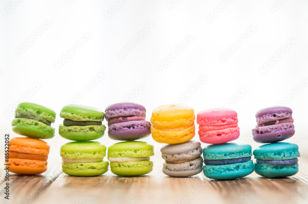 French colorful macarons on wood table French colorful macarons on wood table