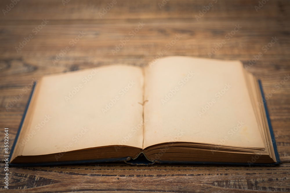 Open blank pages of old book on wood background Open blank pages of old book on wood background