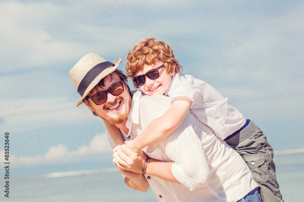 Hipster father with beard and red haired son having happy summer Hipster father with beard and red haired son having happy summer