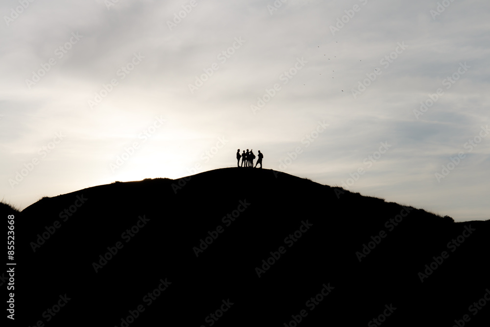 silhouettes of tourists on mountains
