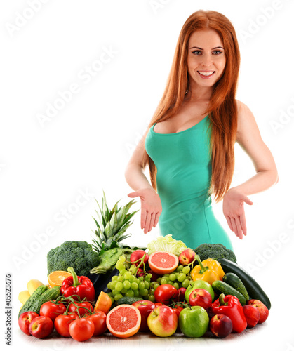 Young woman with variety of organic vegetables and fruits