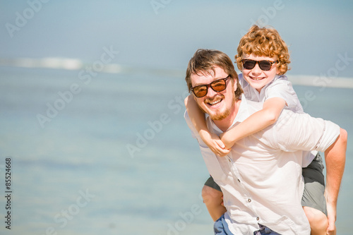 Hipster father with beard and red haired son wearing sunglasses