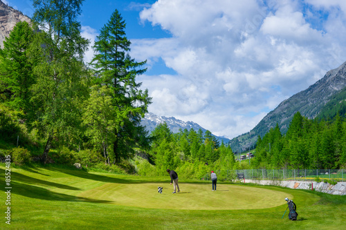 Two people playing golf at Alpine Golf Course, Zermatt, Switzerland