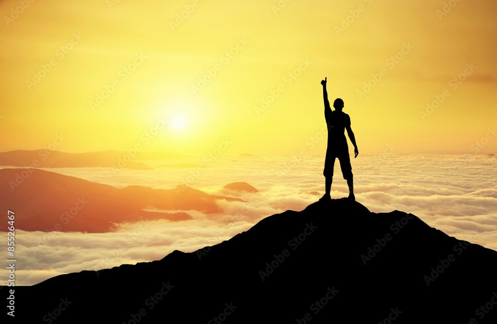 Winner silhouette on the mountain top. Sport and active life concept.