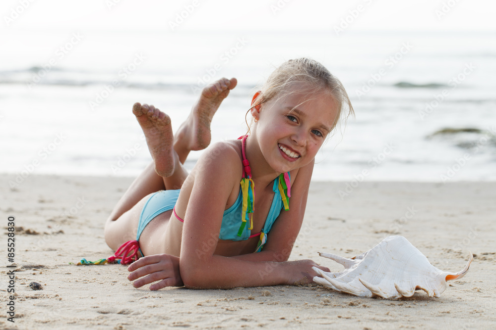 Little girl having fun on a beach Stock Photo | Adobe Stock