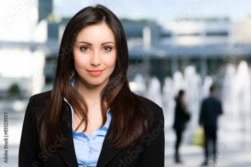 Portrait of a smiling businesswoman outdoor Free Download Portrait of a smiling businesswoman outdoor - GFXLoad