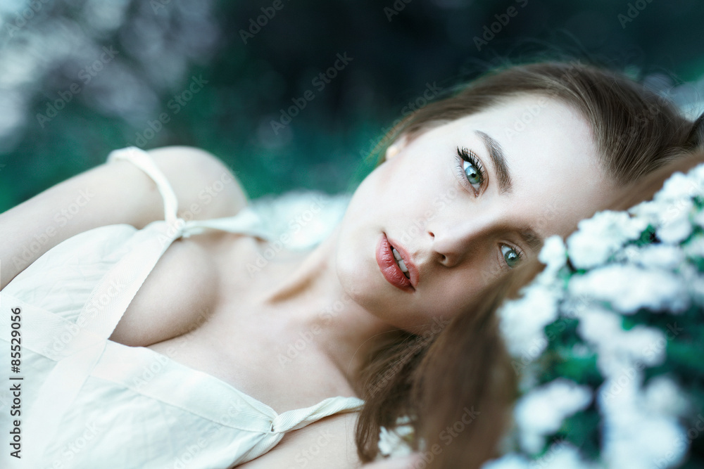 Beautiful sensual girl lying on flower meadow Beautiful sensual girl lying on flower meadow