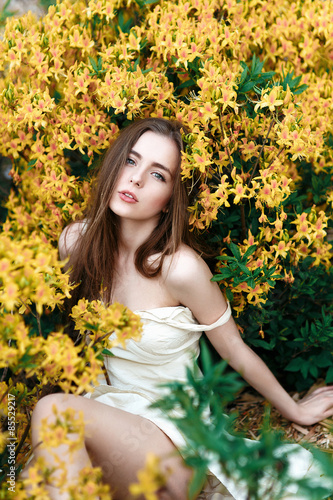 portrait of young lovely girl in spring flowers