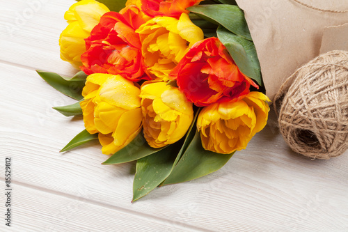 Fototapeta Naklejka Na Ścianę i Meble -  Colorful tulips over wooden table