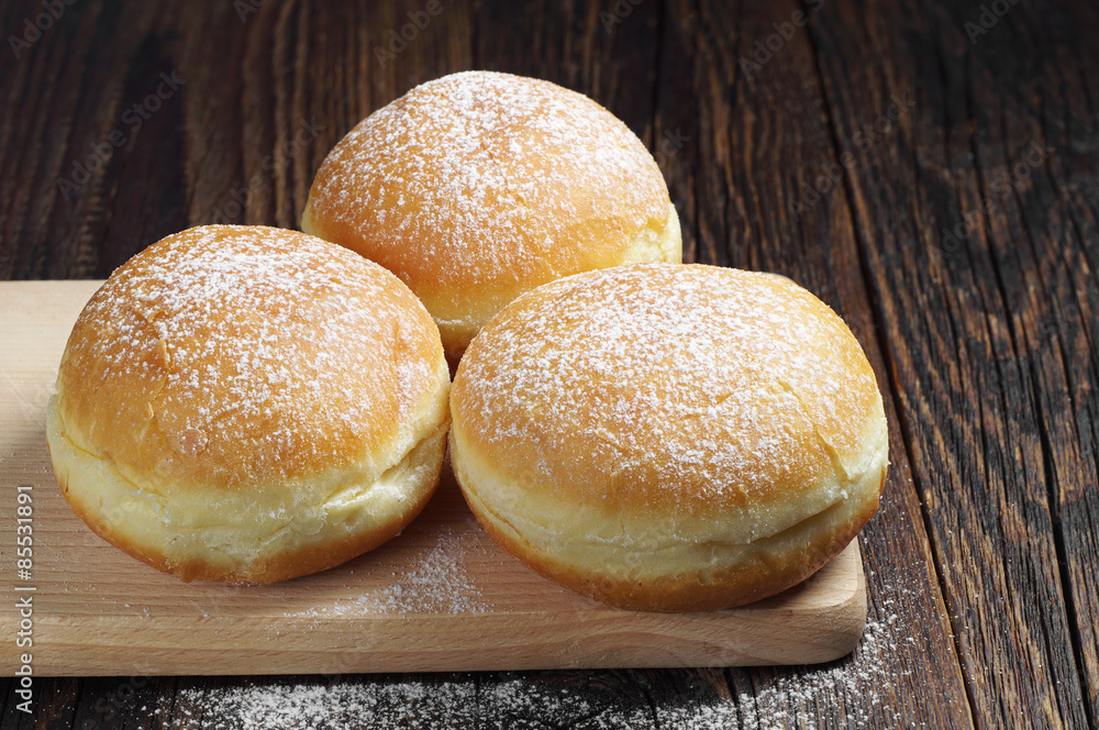 Traditional doughnuts with powdered sugar Traditional doughnuts with powdered sugar
