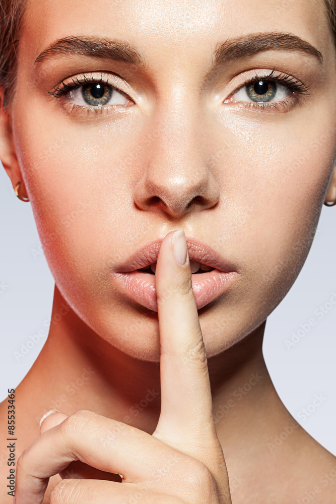Portrait of beautiful woman with a finger to his lips Portrait of beautiful woman with a finger to his lips