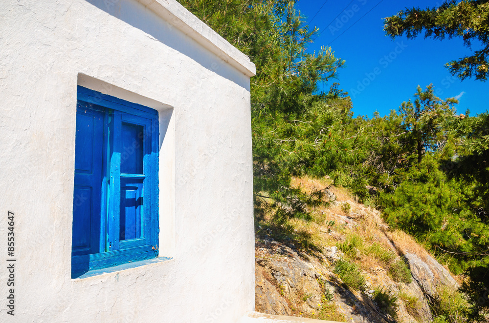 Blue wooden window against clear white wall