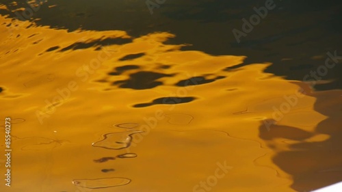 Golder Wellenschlag am Ufer eines Sees im Abendlicht erinnert an flüssiges Gold photo