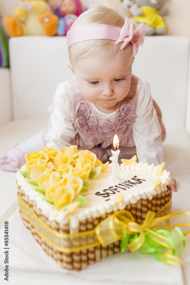 portrait of sitting toddler girl with her birthday cake portrait of sitting toddler girl with her birthday cake