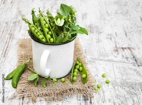 Metal cup with fresh peas