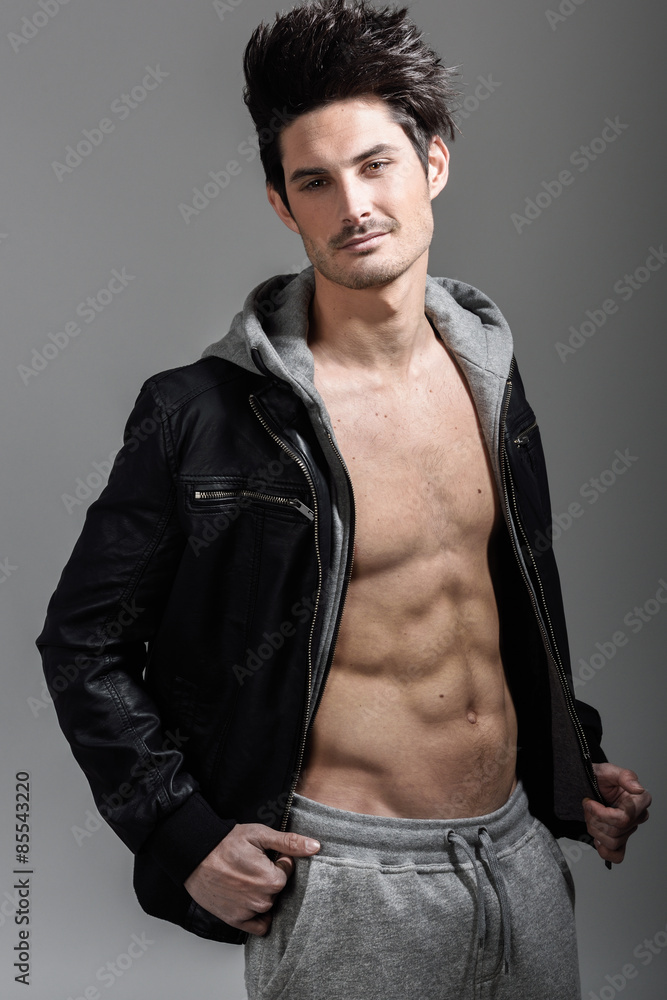 Athletic man wearing hoodie jacket. Studio shot Athletic man wearing hoodie jacket. Studio shot