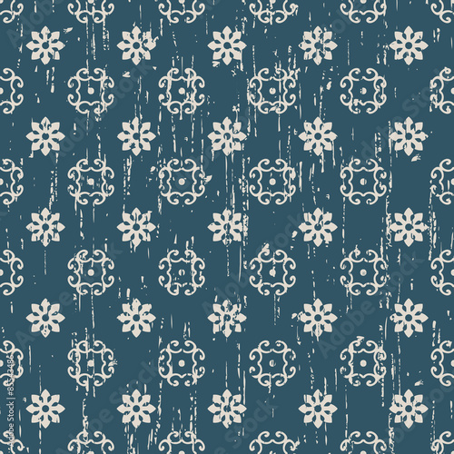 Seamless worn out flower tracery pattern background.
