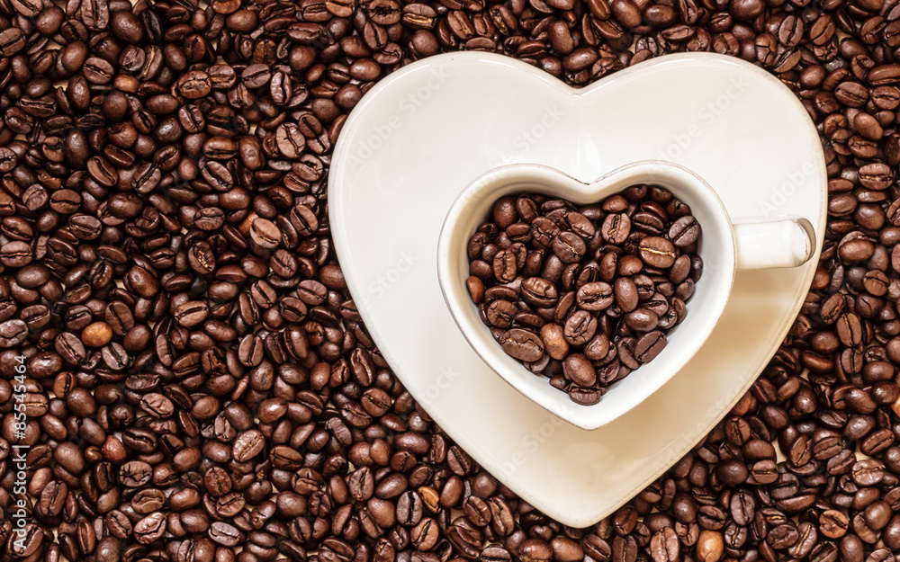cup and saucer on coffee beans background cup and saucer on coffee beans background