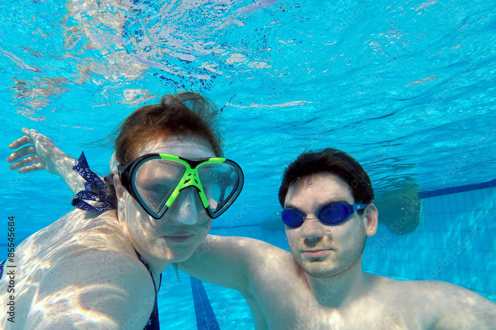 Paar taucht unterwasser im Schwimmbad