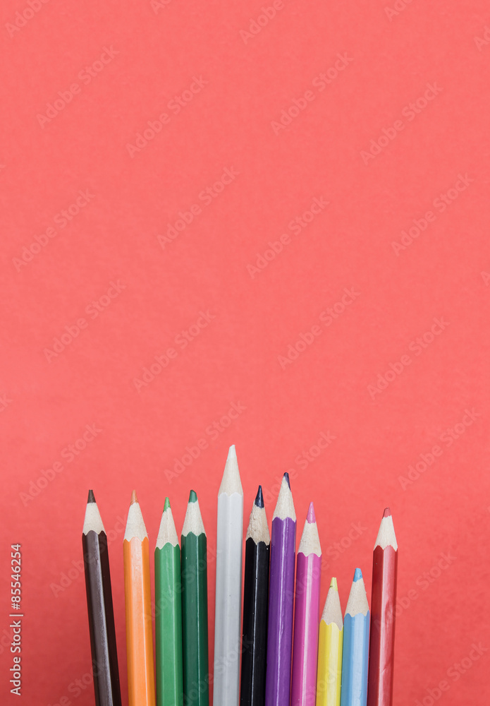 Colored pencils on red background Colored pencils on red background