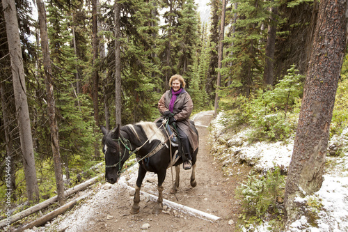 horseback riding through forest trail