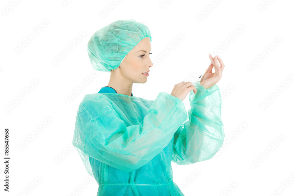 Surgeon doctor with a syringe in hand. Surgeon doctor with a syringe in hand.