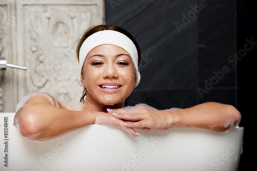 Bathing woman relaxing in bath.
