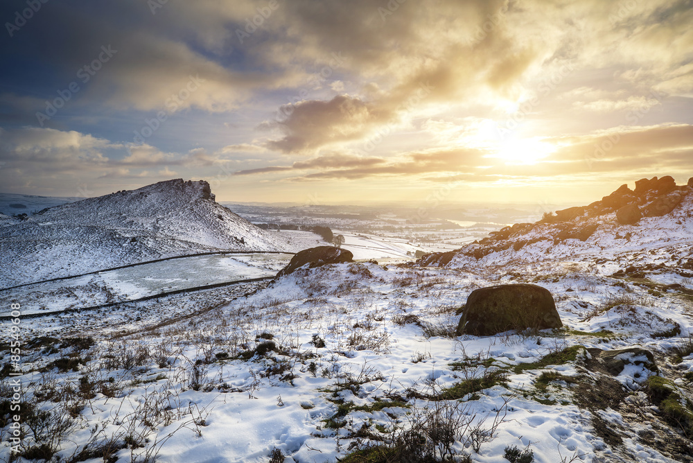 Fototapeta premium Stunning Winter sunset over countryside landscape with dramatic