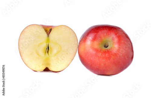 whole and half cut red apples with stem on white background