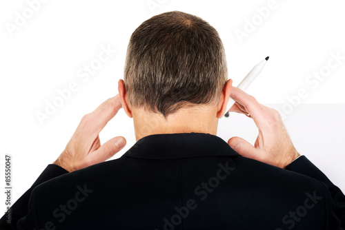 Male executive thinking about presentation