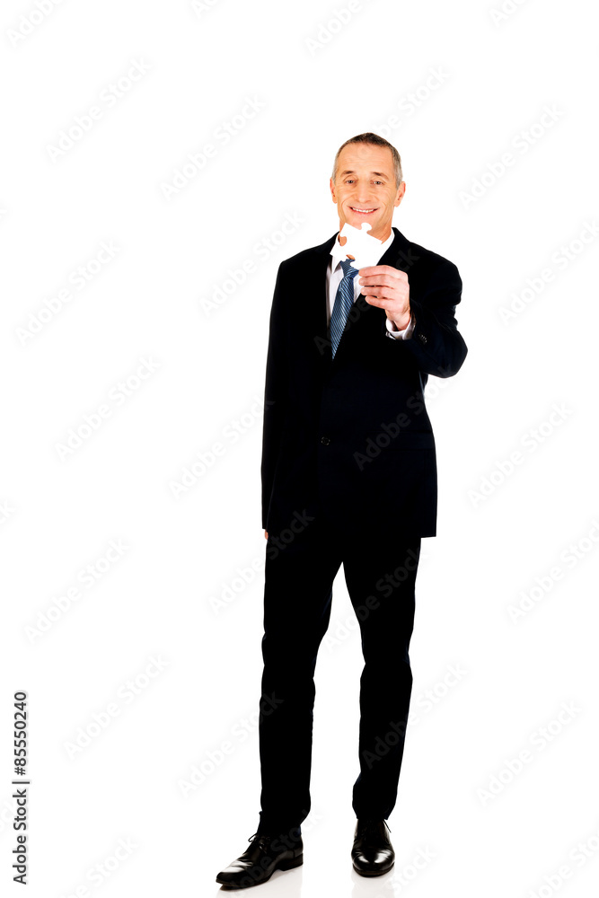 Smart businessman holding a puzzle Smart businessman holding a puzzle
