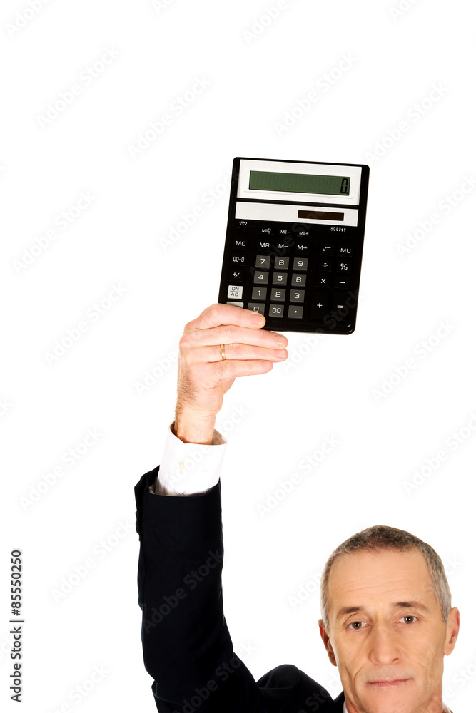 Mature businessman holding a calculator above head Mature businessman holding a calculator above head
