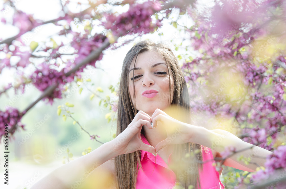 Fototapeta premium Beautiful fit lady between blossom tree in purple color