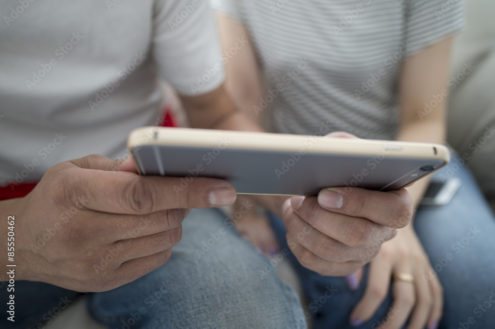Men and women are looking at smartphone together Men and women are looking at smartphone together