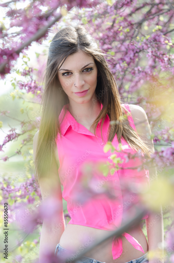 Beautiful fit lady between blossom tree in purple color Beautiful fit lady between blossom tree in purple color